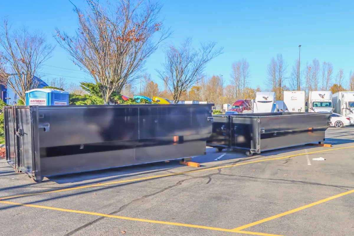 Professional dumpster rental service with roll-off container on residential driveway in Makawao